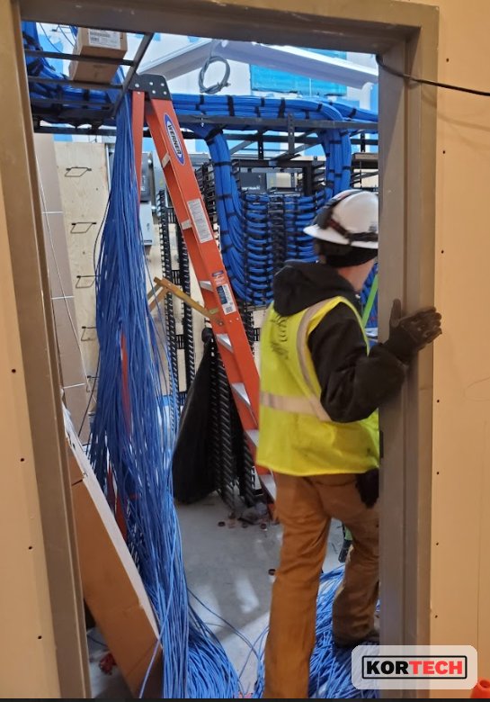 Kortech technician installing inside-plant structured cabling on site